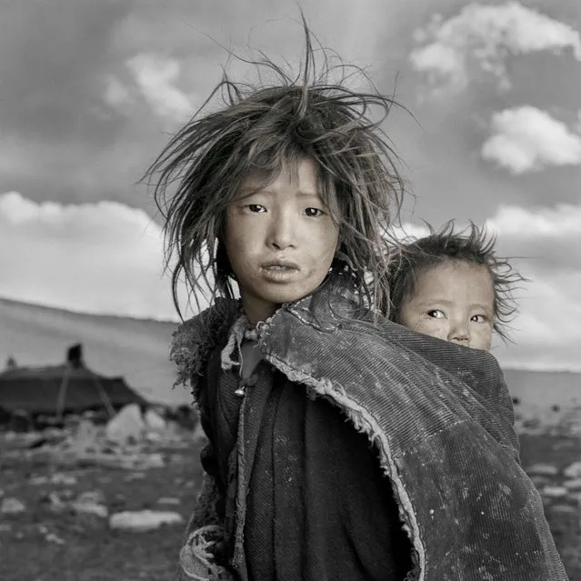 “Jigme and Sonam are sisters whose nomadic family had just come down from the Himalayan highlands to their 16,500 ft. winter camp on the Tibetan Plateau. When I gave Jigme a Polaroid of herself she looked at it, squealed and ran into her tent. I assumed that this was one of the only times she had seen herself since her family did not own a mirror”. (Phil Borges)