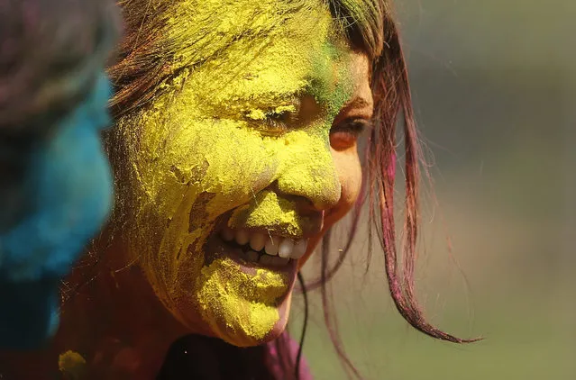 A girl with her face smeared in coloured powder smiles while celebrating Holi in Mumbai, India March 24, 2016. (Photo by Shailesh Andrade/Reuters)