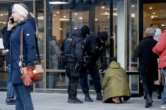 Police officers check a person outside the Oktyabrsky Concert Hall, amid heightened security measures, prior to the concert of the rock group “Picnic” in St. Petersburg, Russia, 27 March 2024. The Russian rock band Picnic was due to perform on 22 March at the Crocus City Hall, where at least 139 people were killed and more than 180 hospitalized after a group of gunmen attacked the concert hall in the Moscow region, according to Russian officials. (Photo by Anatoly Maltsev/EPA/EFE)