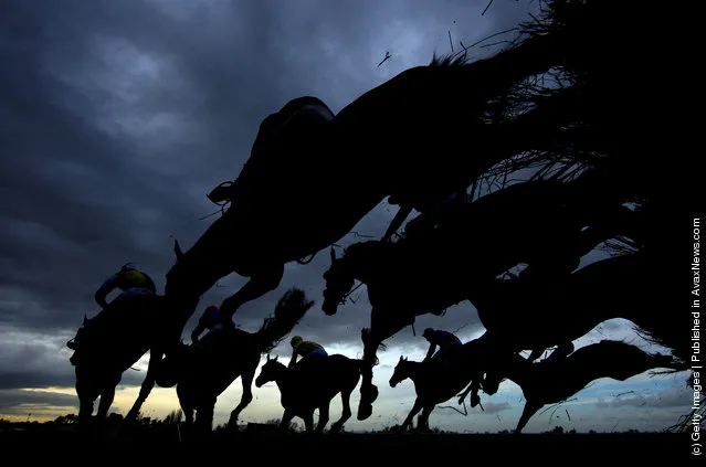 Runners and riders jump a fence in The Fulke Walwyn Kim Muir Challenge Cup Handicap Chase run during day three of the Cheltenham Festival at Cheltenham racecourse