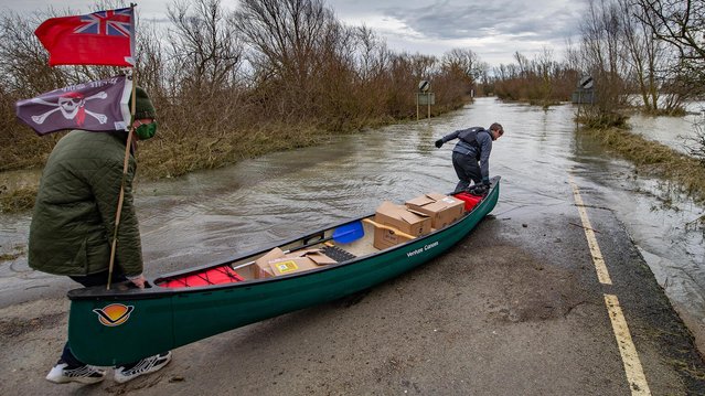 Valentine’s Day meals were delivered by canoe from the Lamb and Flag pub to customers across the Welney Washes on the Cambridgeshire-Norfolk border, United Kingdom on February 14, 2021 where flooding has closed the road. (Photo by Terry Harris/The Times)
