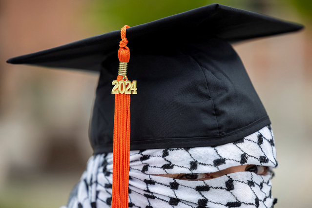 A Palestinian student, who plans to return to his homeland after graduation and who wishes to remain anonymous, poses for a portrait while wearing a keffiyeh along with his commencement cap and 2024 tassel, amid the ongoing conflict between Israel and the Palestinian Islamist group Hamas, at the Auraria Campus in Denver, Colorado, on May 10, 2024. (Photo by Kevin Mohatt/Reuters)