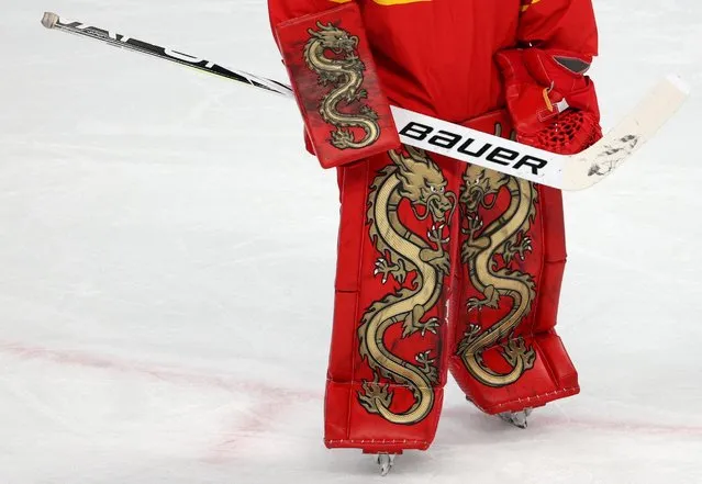 Detail of China's goaltender Zhou Jiaying's leg pads taken as she defends her goal during the women's preliminary round group B match of the Beijing 2022 Winter Olympic Games ice hockey competition against Japan, at the Wukesong Sports Centre in Beijing on February 6, 2022. (Photo by Brian Snyder/Reuters)