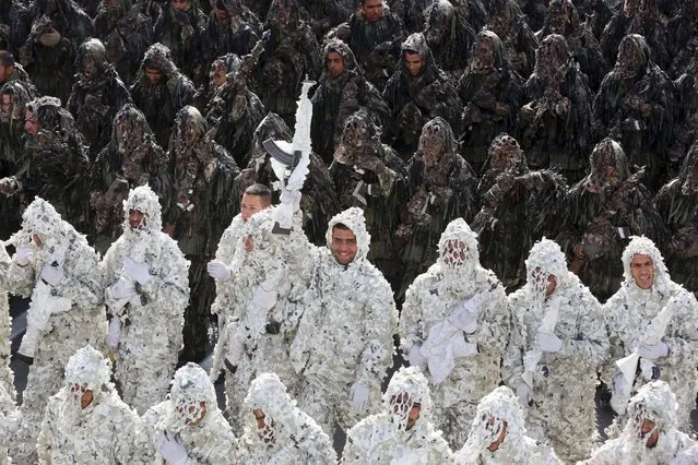 Wearing ghillie suits, Iranian army troops march in a parade marking National Army Day in front of the mausoleum of the late revolutionary founder, Ayatollah Khomeini, just outside Tehran, Iran, April 18, 2014. (Photo by Vahid Salemi/AP Photo)
