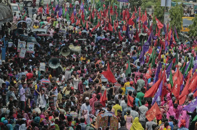 Bangladeshi workers and activists participate in a May Day rally in Dhaka, Bangladesh, Sunday, May 1, 2016. Trade unions and other groups were staging rallies around the world Sunday to mark International Workers Day. (Photo by A.M. Ahad/AP Photo)