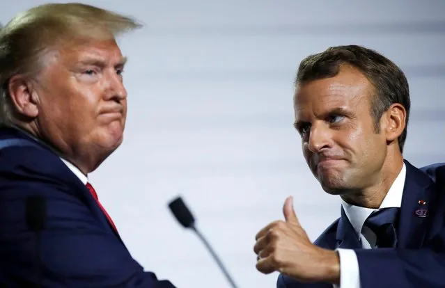 French President Emmanuel Macron and U.S. President Donald Trump react during a news conference at the end of the G7 summit in Biarritz, France, August 26, 2019. (Photo by Carlos Barria/Reuters)