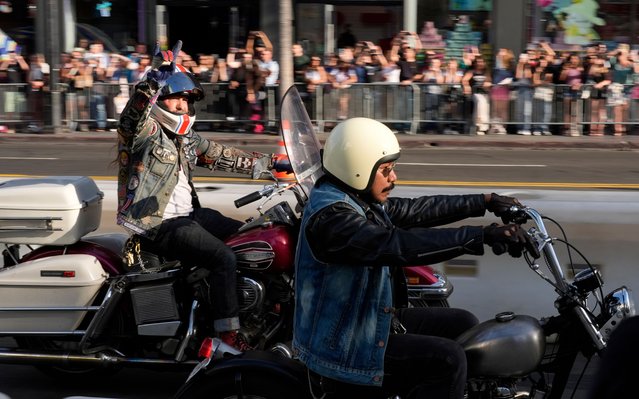 Motorcyclists cruise down Hollywood Boulevard during the premiere of the film "The Bikeriders" at the TCL Chinese Theatre, Monday, June 17, 2024, in Los Angeles. (Photo by Chris Pizzello/AP Photo)