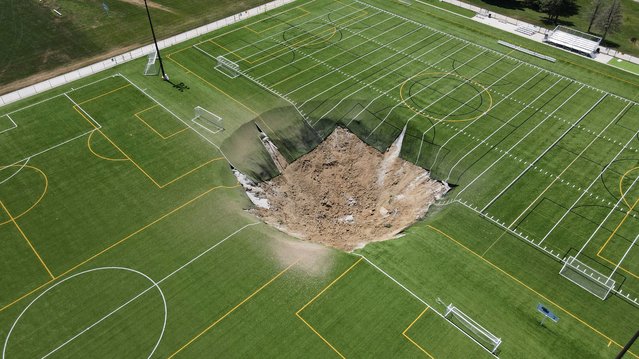 A drone view shows a sinkhole that formed on a turf soccer field at Gordon Moore Park in Alton, Illinois, on June 27, 2024. (Photo by Lawrence Bryant/Reuters)