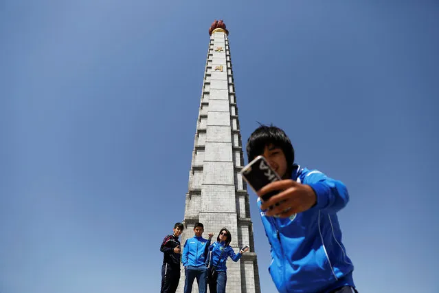 Members of Uzbekistan women football team take pictures of themselves under the 170-metre (558-feet) tall Juche Tower in central Pyongyang, North Korea April 12, 2017. (Photo by Damir Sagolj/Reuters)