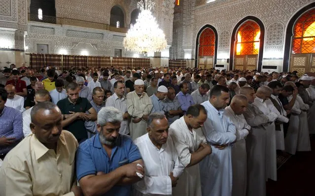 Sunni worshippers attend prayers at a Sunni mosque during Eid al-Fitr in Baghdad, July 17, 2015. Iraq's Sunni Muslims celebrated the first day of Eid al-Fitr a day ahead of Shi'ite Muslims. Worshippers gathered at the central Baghdad 17th Ramadan mosque. (Photo by Ahmed Saad/Reuters)
