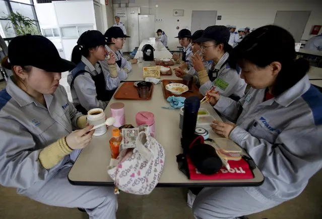 Employees of Daikin Industries Ltd have lunch at the company's Kusatsu factory in Shiga prefecture, western Japan in this March 20, 2015 file photo. (Photo by Yuya Shino/Reuters)