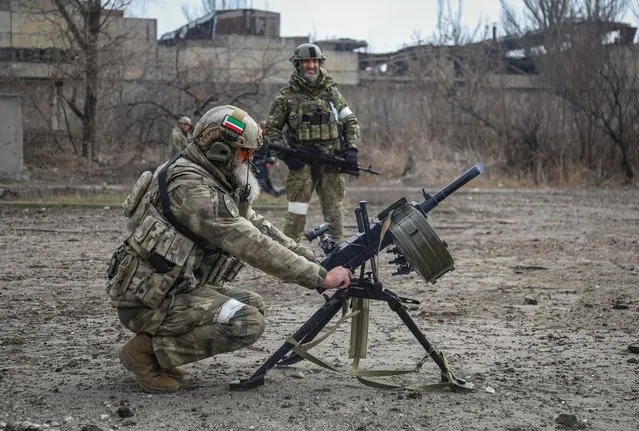 Zamid Chalaev regiment commander from Chechen Republic fires an automatic grenade launcher during fighting in the Ukraine-Russia conflict in the city of Mariupol, Ukraine on March 31, 2022. (Photo by Chingis Kondarov/Reuters)