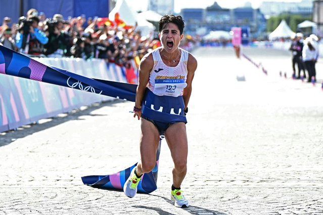 Spain's Maria Perez celebrates after winning the mixed marathon race walk relay of the athletics event at the Paris 2024 Olympic Games at Trocadero in Paris on August 7, 2024. (Photo by Gabriel Bouys/AFP Photo)