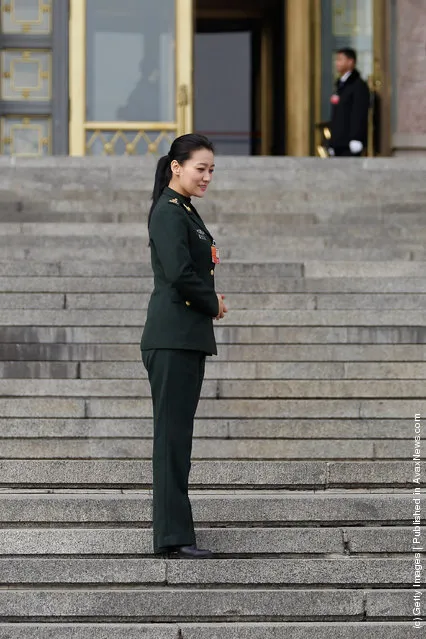 Chinese singer delegate Tan Jing poses for photos outside The Great Hall Of The People after the second plenary meeting of the National People's Congress (NPC)