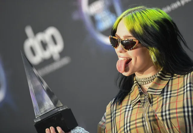 US singer/songwriter Billie Eilish poses with her awards for New Artist of the Year and Alternative Artist in the press room during the 2019 American Music Awards at the Microsoft theatre on November 24, 2019 in Los Angeles. (Photo by Valerie Macon/AFP Photo)