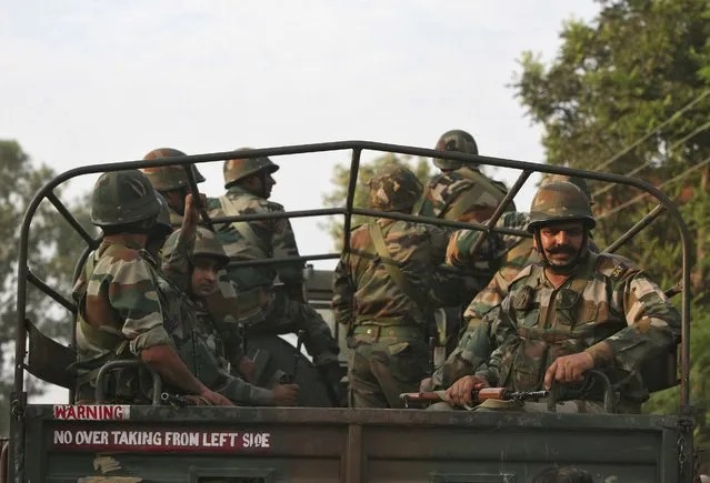 Indian soldiers sit in a truck after a gunfight in Dinanagar town in Gurdaspur district of Punjab, India, July 27, 2015. (Photo by Mukesh Gupta/Reuters)