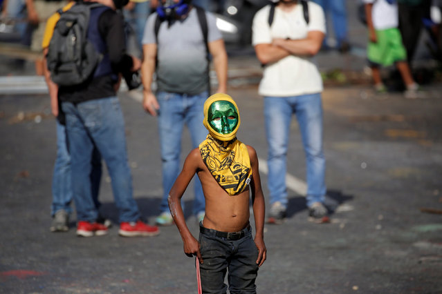 A boy takes part in a protest against the country’s president, Nicolas Maduro in Caracas, Venezuela on June 11, 2017. (Photo by Ivan Alvarado/Reuters)