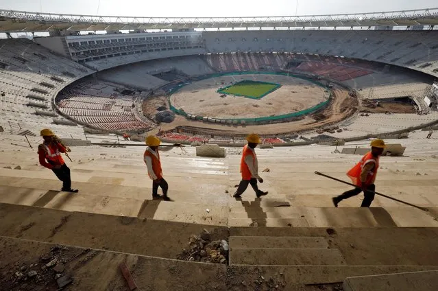Workers are pictured at the construction site of Sardar Patel Gujarat Stadium, which according to local media is the largest cricket stadium in the world with a seating capacity of around 110,000, in Ahmedabad, December 12, 2019. (Photo by Amit Dave/Reuters)