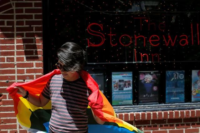 Cameron Cano of Miami, Florida stands outside the Stonewall Inn on Christopher Street, considered by some as the center of New York State's gay rights movement, following the shooting massacre at Orlando's Pulse nightclub, in the Manhattan borough of New York, U.S., June 12, 2016. (Photo by Andrew Kelly/Reuters)