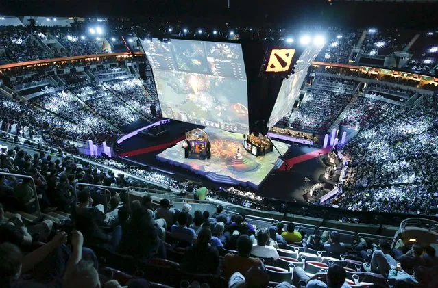 Fans watch a competition during The International Dota 2 Championships at Key Arena in Seattle, Washington August 8, 2015. (Photo by Jason Redmond/Reuters)
