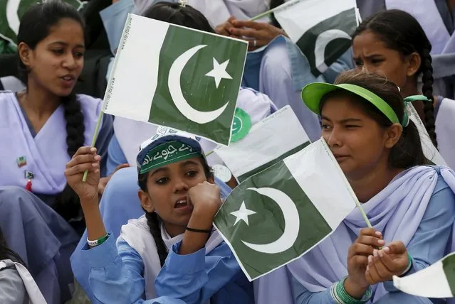 Students hold national flags during a ceremony to celebrate the country's 69th Independence Day at the mausoleum of Muhammad Ali Jinnah in Karachi, Pakistan, August 14, 2015. Jinnah is generally regarded as the founder of Pakistan. (Photo by Akhtar Soomro/Reuters)