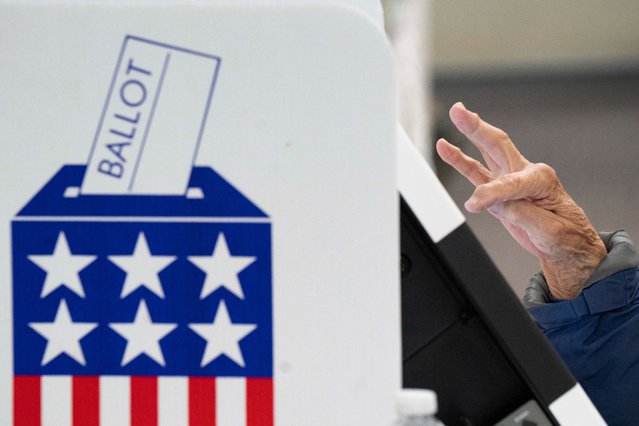 A person votes during early voting at a polling station in Black Mountain, North Carolina on October 18, 2024. (Photo by Allison Joyce/AFP Photo)