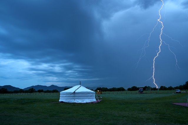 A lightning strikes near Hantay at Bulgan province in Mongolia on July 3, 2024. (Photo by Hector Retamal/AFP Photo)