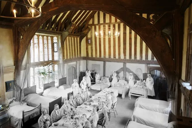 Soldiers and nurses at Great Dixter, East Sussex, in 1916, sit at a table in the Great Hall at Great Dixter, with some still in bed. Great Dixter was turned into a convalescent home for soldiers in the 1st World War. (Photo by Peter Macdiarmid/Getty Images)
