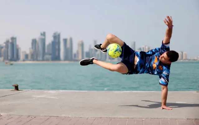 A freestyle footballer performs ahead of the draw at the World Cup 2022 in Doha, Qatar on April 1, 2022. (Photo by Carl Recine/Reuters)