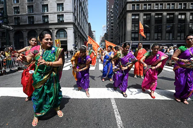 Women in colorful saris dance along Madison Avenue as they participate in the 47th Annual India Day Parade on August 20, 2017 in New York. (Photo by Anthony Behar/ddp USA/Barcroft Images)