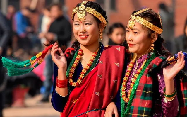 Members of the indigenous Gurung community wearing traditional attire react as they take part in a New Year celebration ceremony known as “Tamu Lhosar” in Kathmandu on December 31, 2019. (Photo by Prakash Mathema/AFP Photo)
