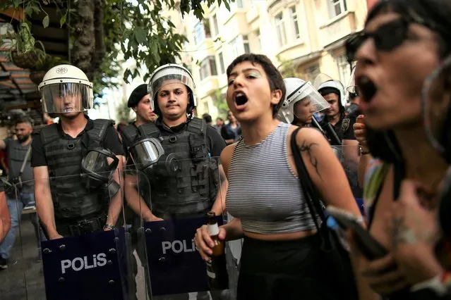 People shout slogans next to Turkish police officers during the LGBTQ Pride March in Istanbul, Turkey, Sunday, June 26, 2022. (Photo by Emrah Gurel/AP Photo)
