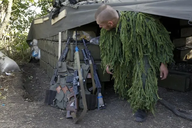 A Ukrainian sniper leaves his shelter at a military camp in Luhansk region August 21, 2014. (Photo by Valentyn Ogirenko/Reuters)