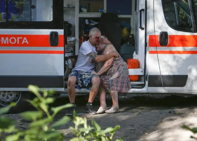 A man comforts a woman who were both wounded by what locals say was recent shelling by Ukrainian forces in Donetsk August 23, 2014. (Photo by Maxim Shemetov/Reuters)