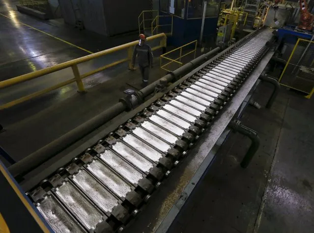 A worker watches aluminium ingots on a conveyor belt at the Rusal Khakassia aluminium smelter outside the town of Sayanogorsk, Russia, September 3, 2015. (Photo by Ilya Naymushin/Reuters)