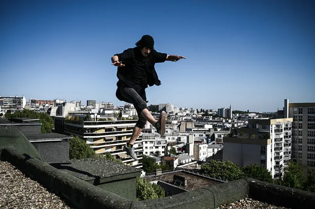 French free-runner Simon jumps as he performs on a rooftop in Paris on April 26, 2020 during a strict lockdown in France aimed at curbing the spread of the COVID-19 infection caused by the novel coronavirus. (Photo by Philippe Lopez/AFP Photo)