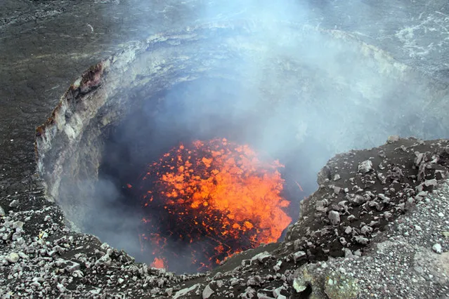 In this February 14, 2011 photo provided by Hawaii Volcano Observatory, a churning lava lake at Kilauea's summit is seen at Hawaii Volcanoes National Park, Hawaii. (Photo by AP Photo/Hawaii Volcano Observatory)