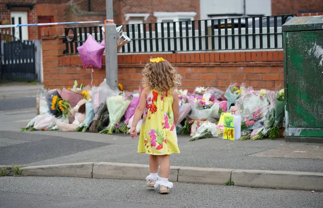 A young girl lays a tribute in Kingsheath Avenue, Knotty Ash, Liverpool on Wednesday, August 24, 2022, where nine-year-old Olivia Pratt-Korbel was fatally shot on Monday night. The people of Liverpool have been urged to turn in the masked gunman who killed Olivia as he chased his intended target into her home. (Photo by Peter Byrne/PA Images via Getty Images)