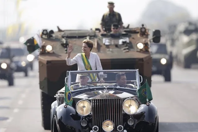 Brazil's President Dilma Rousseff waves in a vehicle during a civic-military parade to commemorate Brazil's Independence Day in Brasilia, Brazil September 7, 2015. (Photo by Ueslei Marcelino/Reuters)