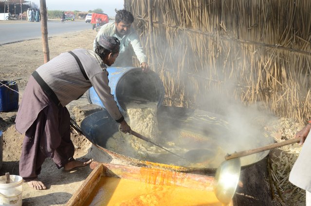 Laborers process sugarcane juice to produce “Gud” (jaggery) at a production unit in Mirpurkhas village, Sindh, Pakistan, 11 December 2024. Gud, a traditional unrefined sugar, is made from sugarcane juice that is boiled in a large iron container while being continuously churned and stirred. The thickened syrup is then left to cool and harden before being sold. Often consumed with or after meals, Gud is also used as a natural sweetener in tea or milk. (Photo by Nadeem Khawer/EPA/EFE)