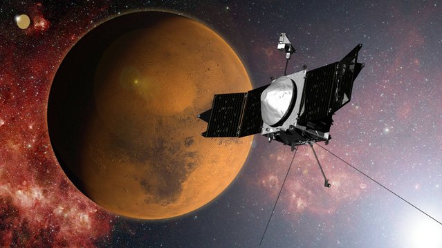 In this artist concept provided by NASA, the MAVEN spacecraft approaches Mars on a mission to study its upper atmosphere. When it arrives on Sunday September 21, 2014, MAVEN's 442 million mile journey from Earth will culminate with a dramatic engine burn, pulling the spacecraft into an elliptical orbit. It's designed to circle the planet, not land. (Photo by AP Photo/NASA)