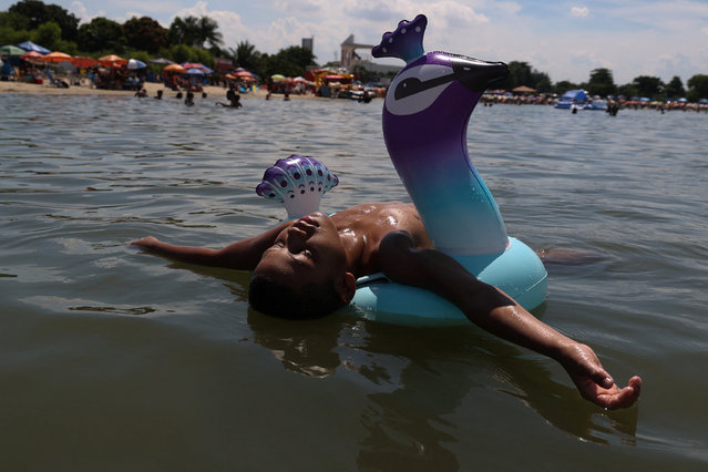 A boy floats at the artificial pond known as Piscinao de Ramos, or big pool, in the northern suburbs of Rio de Janeiro, Brazil on February 9, 2025. (Photo by Aline Massuca/Reuters)