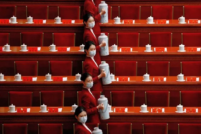 Attendants serve tea for delegates before the opening ceremony of the 20th National Congress of the Communist Party of China, at the Great Hall of the People in Beijing, China on October 16, 2022. (Photo by Thomas Peter/Reuters)