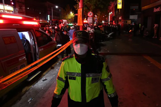 Police at the scene of a stampede on October 30, 2022 in Seoul, South Korea. At least 50 people were reported to be receiving CPR after suffering from cardiac arrest in Seoul's Itaewon area as huge crowds of people stampeded at Halloween parties, according to authorities. (Photo by Chung Sung-Jun/Getty Images)