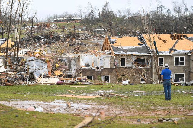 A man looks at debris on the ground after apartments were struck by a tornado in Selmer, Tennessee, U.S., April 3, 2025. (Photo by Jamar Coach/The Jackson Sun/USA TODAY NETWORK via Imagn Images)