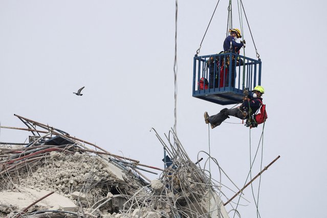 Rescue personnel work at the site of a building that collapsed, following a strong earthquake, in Bangkok, Thailand on March 30, 2025. (Photo by Patipat Janthong/Reuters)