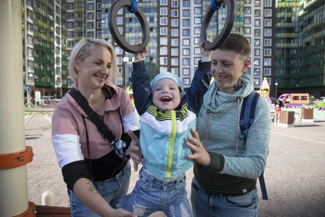 Irina, right, and Anastasia Lagutenko play with their son, Dorian, at a playground in St. Petersburg, Russia, July 2, 2020. Their 2017 wedding wasn’t legally recognized in Russia. Any hopes they could someday officially be married in their homeland vanished July 1 when voters approved a package of constitutional amendments, one of which stipulates that marriage in Russia is only between a man and a woman. (Photo by AP Photo/Stringer)