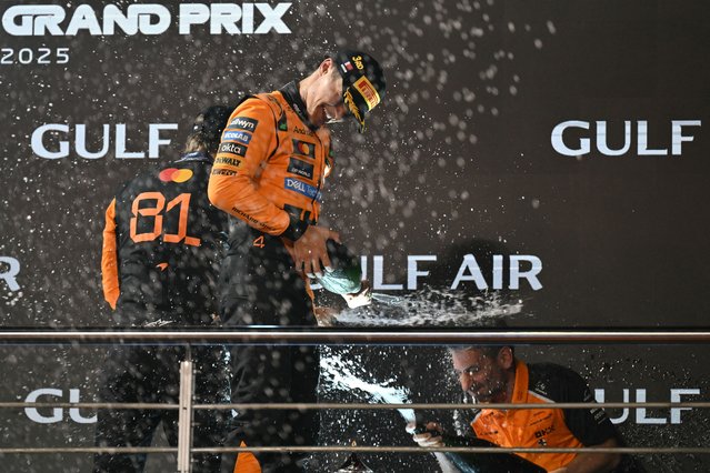 McLaren's Australian driver Oscar Piastri, McLaren team principal Andrea Stella and McLaren's British driver Lando Norris celebrate on the podium after the Bahrain Formula One Grand Prix at the Bahrain International Circuit in Sakhir on April 13, 2025. (Photo by Andrej Isakovic/AFP Photo)