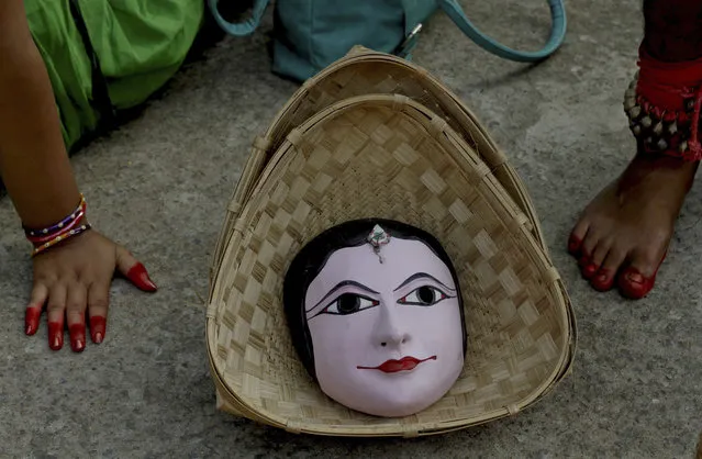 A traditional handmade mask is kept in a bamboo basket as cultural artists from India’s Jharkhand state wait to perform at a World Tourism Day carnival in Bhubaneswar, India, Sunday, September 27, 2015. (Photo by Biswaranjan Rout/AP Photo)