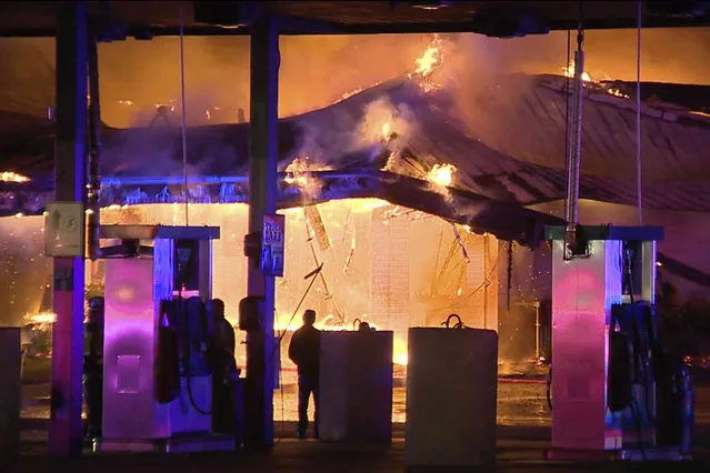 In this image taken from a video provided by KSAT-TV, a flames rise from a truck stop in San Antonio, Texas, early Thursday morning, December 1, 2022. (Photo by KSAT-TV via AP Photo)